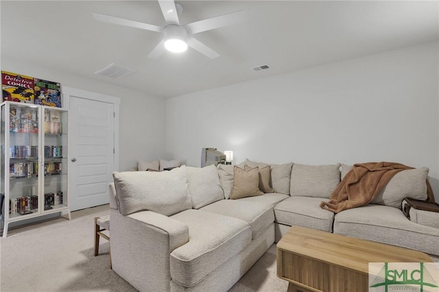 living room featuring light carpet, visible vents, and ceiling fan