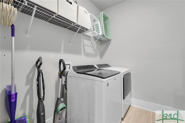 laundry area featuring washer and dryer, baseboards, and laundry area