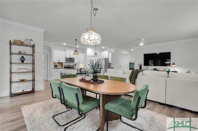 dining space with ornamental molding, ceiling fan, and light hardwood / wood-style flooring