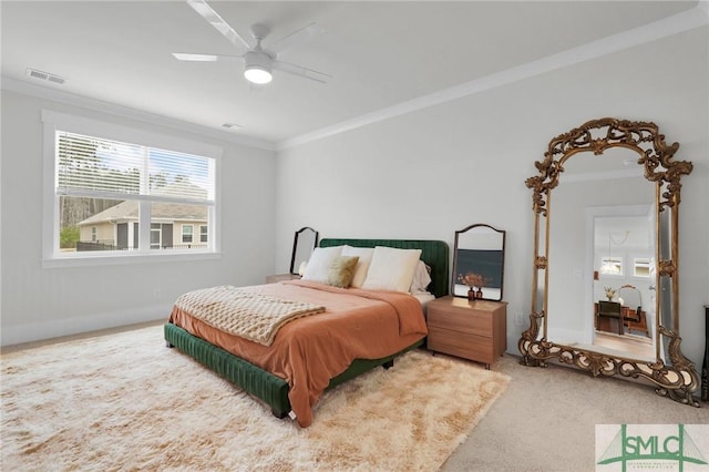 bedroom with carpet flooring, a ceiling fan, visible vents, and ornamental molding