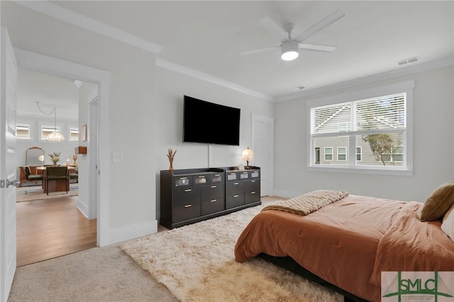 bedroom featuring crown molding, multiple windows, and visible vents