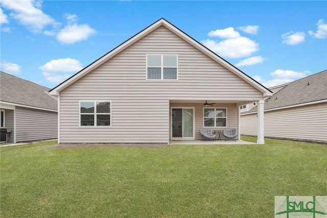 back of house with central AC, ceiling fan, a patio area, and a lawn