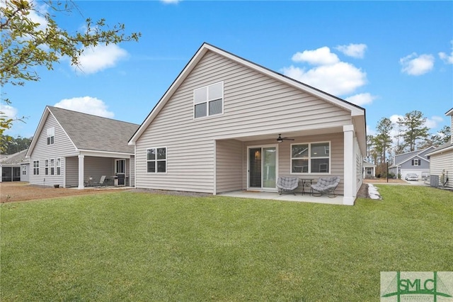 rear view of house featuring a patio area, ceiling fan, and a lawn