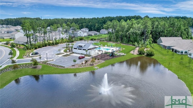 birds eye view of property featuring a forest view, a water view, and a residential view