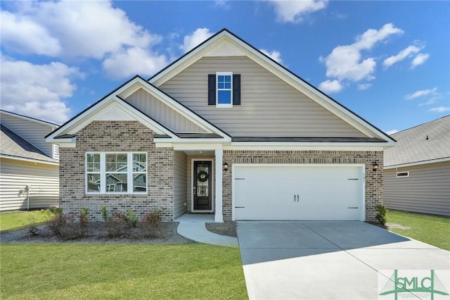 view of front facade featuring a front yard, an attached garage, brick siding, and driveway