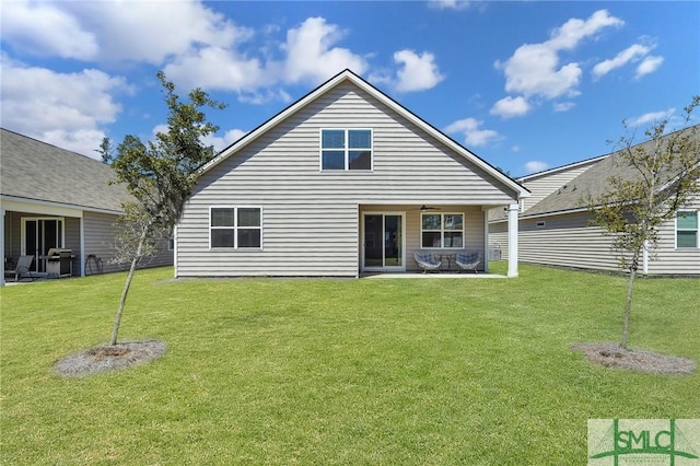 back of house featuring a yard, a patio area, and ceiling fan