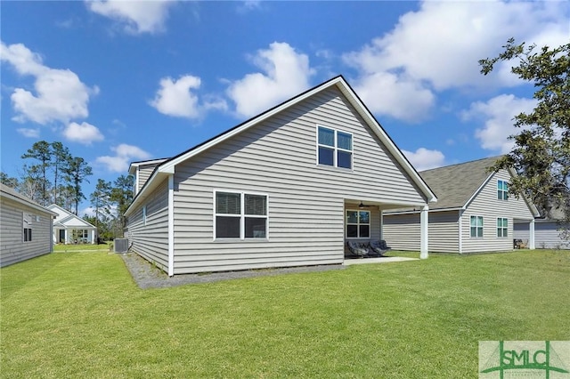 back of property with a yard and central AC unit