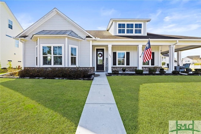 view of front of house with covered porch and a front yard