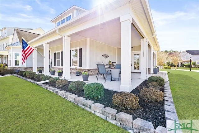 back of house with a lawn and a porch