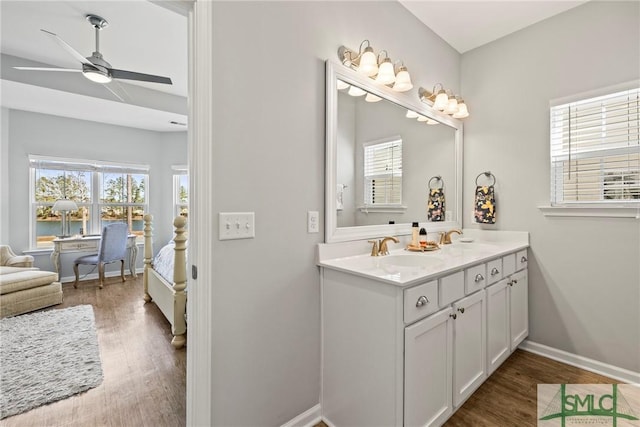 bathroom with hardwood / wood-style flooring, ceiling fan, and vanity