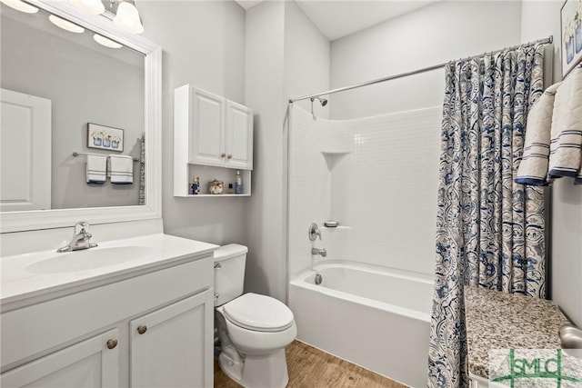 full bathroom with hardwood / wood-style flooring, vanity, toilet, and shower / bath combo