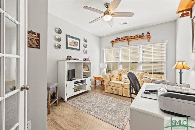 home office featuring ceiling fan and light hardwood / wood-style flooring