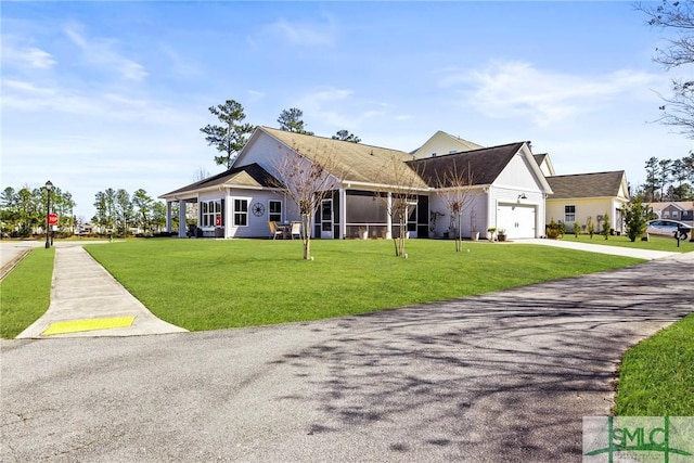 view of front of property with a garage and a front yard