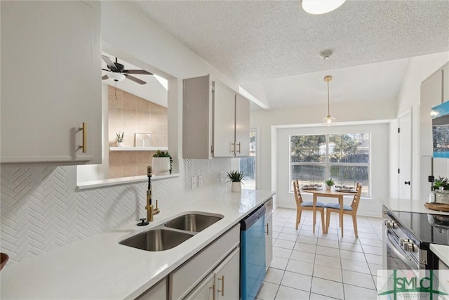 kitchen with sink, light tile patterned floors, gray cabinets, stainless steel appliances, and decorative backsplash