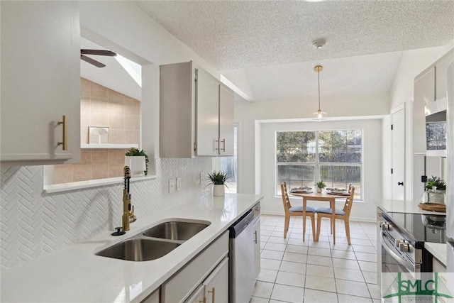 kitchen with pendant lighting, sink, gray cabinets, appliances with stainless steel finishes, and light tile patterned flooring