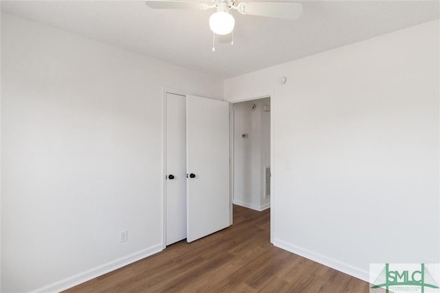 empty room featuring wood-type flooring and ceiling fan