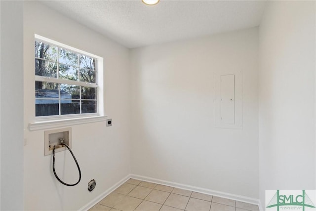 washroom with hookup for a washing machine, hookup for an electric dryer, electric panel, and light tile patterned floors