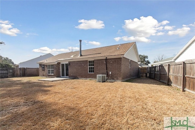 rear view of house featuring central AC, a yard, and a patio