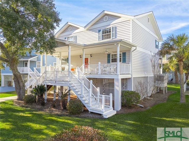 5 Shipwatch Cir, Tybee Island, GA 31328 - coastal inspired home featuring a porch, a front yard, and stairs