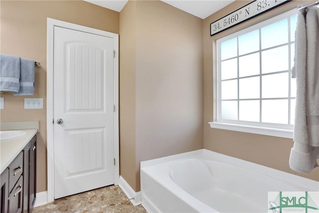 bathroom featuring vanity and a bath