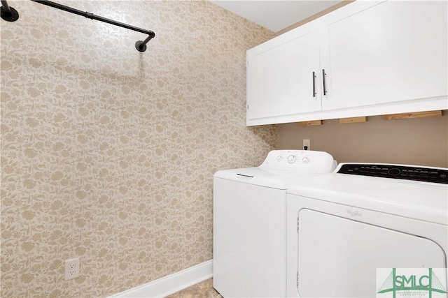 laundry area featuring cabinets and washing machine and dryer