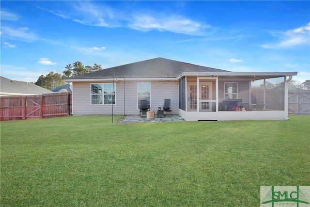 back of house with a sunroom, a yard, and a patio area