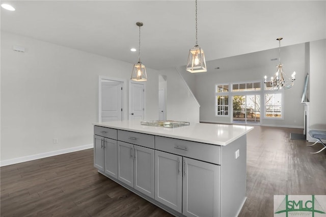 kitchen featuring a center island, gray cabinets, and hanging light fixtures