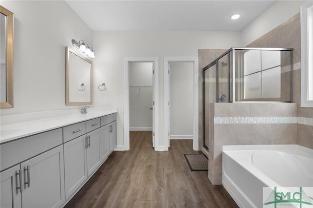 bathroom with vanity, hardwood / wood-style flooring, and separate shower and tub