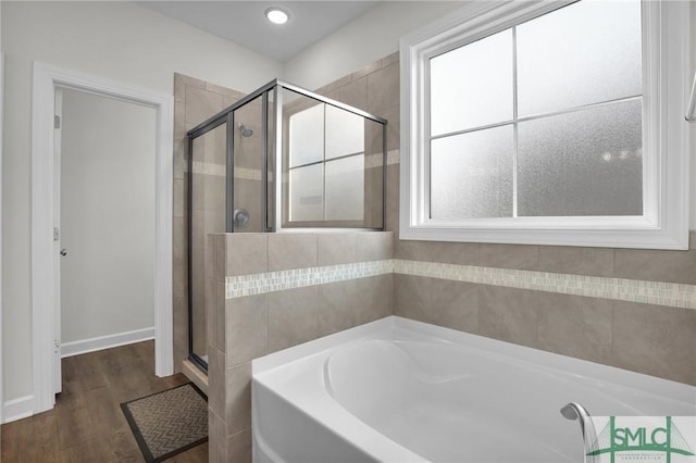 bathroom with wood-type flooring and separate shower and tub