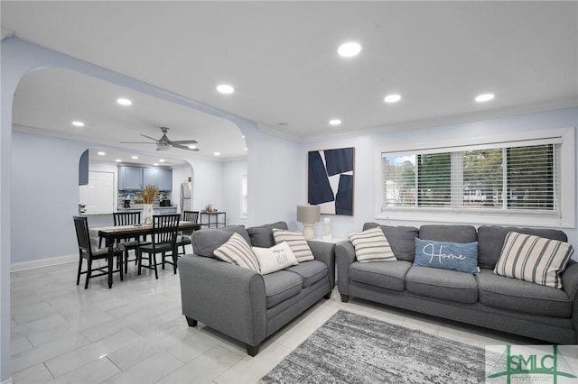 living room with ceiling fan and ornamental molding