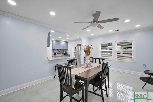 dining room featuring crown molding and ceiling fan