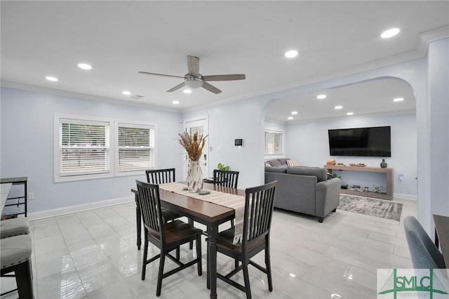 dining space with light tile patterned flooring, ceiling fan, and ornamental molding