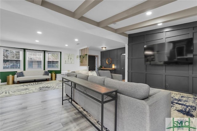 living room featuring light wood-type flooring and beam ceiling