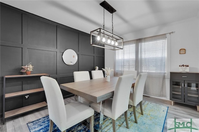 dining space with a chandelier and light hardwood / wood-style flooring