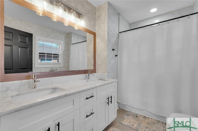 bathroom featuring tile patterned flooring and vanity