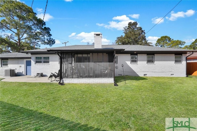 rear view of house featuring central AC unit, a patio area, a sunroom, and a lawn