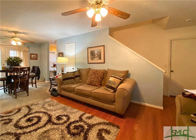 living room with hardwood / wood-style flooring and ceiling fan