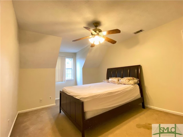 carpeted bedroom with vaulted ceiling and ceiling fan