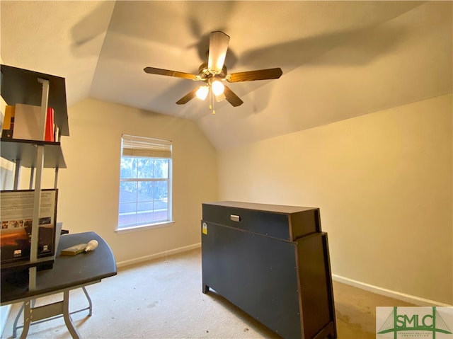 carpeted home office with vaulted ceiling and ceiling fan