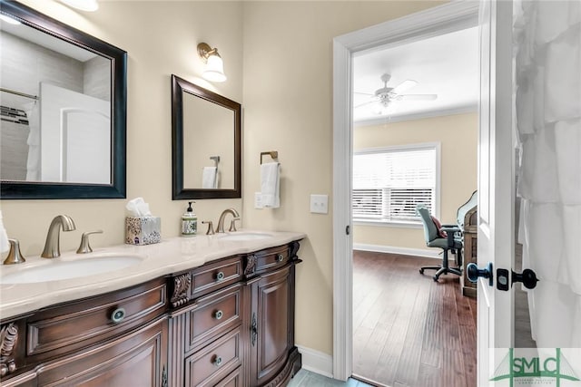 bathroom with vanity, hardwood / wood-style floors, ornamental molding, and ceiling fan