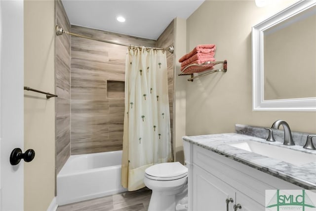 full bathroom with vanity, hardwood / wood-style floors, toilet, and shower / bath combo