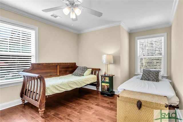 bedroom with ceiling fan, multiple windows, ornamental molding, and wood-type flooring