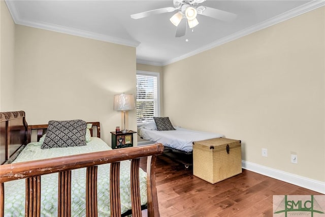 bedroom with ornamental molding, dark hardwood / wood-style floors, and ceiling fan