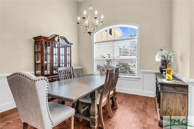 dining space featuring dark hardwood / wood-style flooring and an inviting chandelier