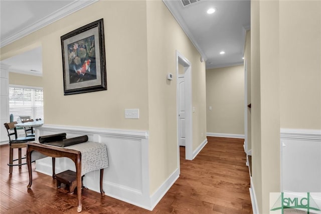 corridor featuring ornamental molding and hardwood / wood-style floors