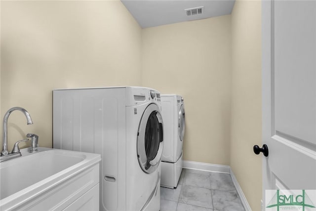 laundry area with washing machine and dryer and sink