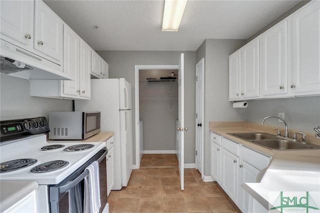 kitchen featuring sink, white electric range, a textured ceiling, white cabinets, and light tile patterned flooring