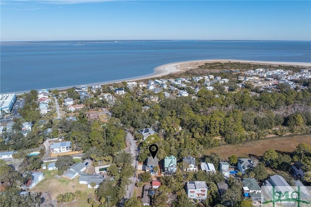 birds eye view of property featuring a water view and a beach view