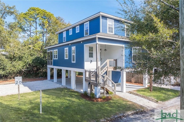 view of front of house with a front yard and a carport