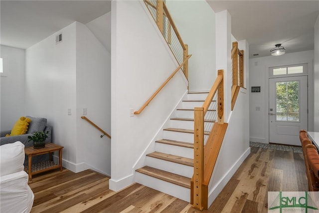 stairs with hardwood / wood-style floors